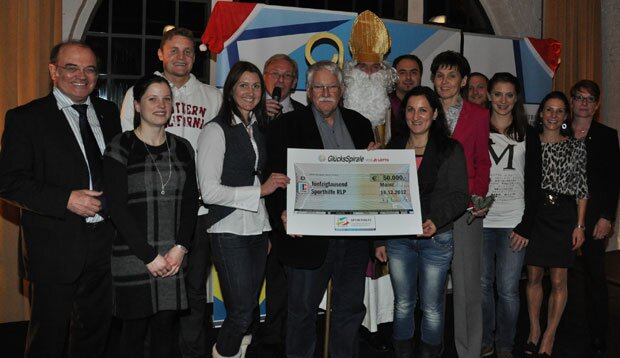 Die offizielle Scheckübergabe mit (v.l.) LSB-Vizepräsident Werner Schröter, Kunstradfahrerin Sandra Sprinkmeier, Schwimmer Dimitri Colupaev, Stabhochspringerin Carolin Hingst, LSB-Hauptgeschäftsführer Lothar Westram, stellvertretender Lotto-Aufsichtsratsvorsitzender Walter Desch, der Weihnachtsmann, Gewichtheber Almir Velagic, Trampolinturnerin Anna Dogonadze, LSB-Präsidentin Karin Augustin, Gewichtheber Jürgen Spieß, Bahnradsprinterin Miriam Welte, Langstreckenläuferin Sabrina Mockenhaupt und LSB-Vizepräsidentin Claudia Altwasser. Foto: C. Palm 2012_scheckbergabe_glckss